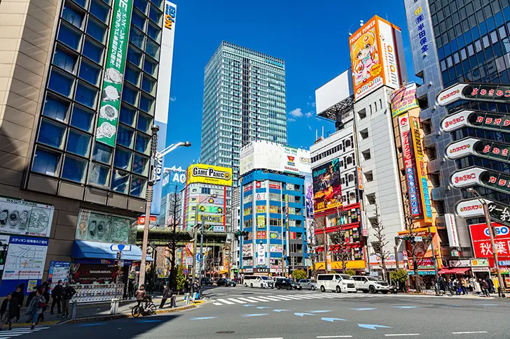 Shibuya Scramble Crossing in Tokyo, a famous landmark known for its busy crowds, neon lights, and dynamic city atmosphere